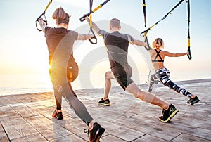 Group of people having Trx training
