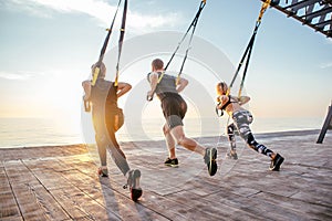 Group of people having Trx training