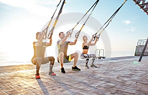 Group of people having Trx training
