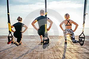 Group of people having Trx training