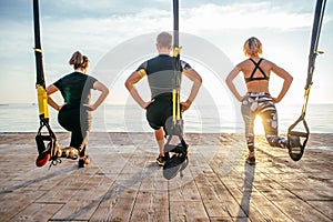 Group of people having Trx training