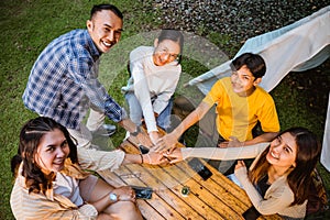 a group of people high fived above the wood table