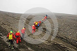 Group of people hiking at Deception Island, Antarctica