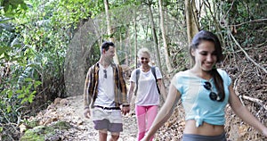 Group of People Hiking In Forest Talking Happy Smiling, Mix Race Tourists Men And Women On Trekking Route During