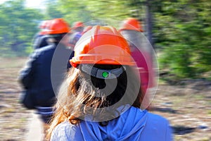 Group people hiking in the forest wearing hard hats