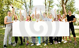 Group of people holding big white paper