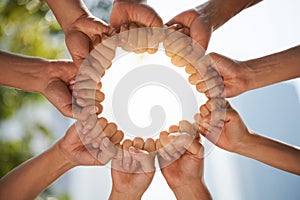 Group of people holding hands in a circle