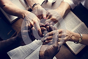 Group of people holding hands praying worship believe