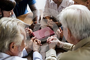 Group of people holding hands praying worship believe