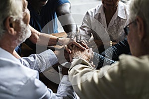 Group of people holding hands praying worship believe