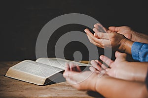 People holding hands praying worship believe