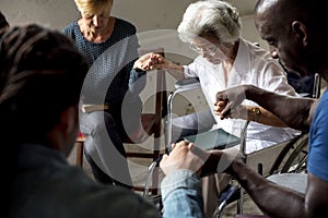 Group of people holding hands praying worship believe