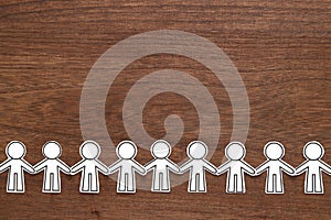 Group of people holding hands on wood. Teamwork concept. Social Network concept.