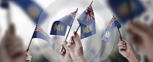 A group of people holding small flags of the Falkland Islands in their hands