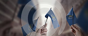 A group of people holding small flags of the World Health Organization WHO in their hands