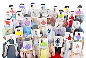 Group of People Holding Tablets in Front of Faces