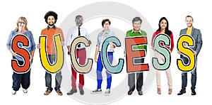 Group of People Holding Word Success