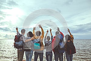 Group of people jumping with their hands up