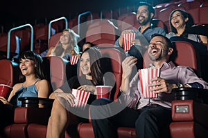 Group of people laughing at the movie theater