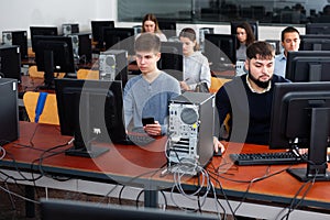 Group of people learning to use computers in classroom