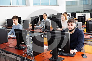 Group of people learning to use computers in classroom