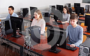 Group of people learning to use computers in classroom