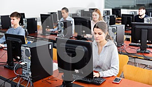 Group of people learning to use computers in classroom