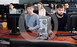 Group of people learning to use computers in classroom