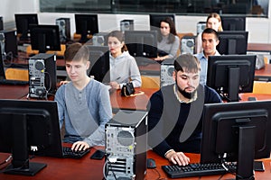 Group of people learning to use computers in classroom