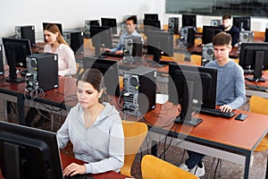 Group of people learning to use computers in classroom