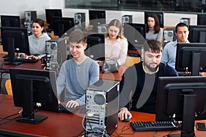 Group of people learning to use computers in classroom