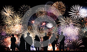 Group of people looks beautiful colorful holiday fireworks