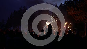 The group of people looks at fireworks.