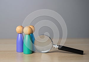 Group of people and magnifying glass, figures. Recruiting, staffing.