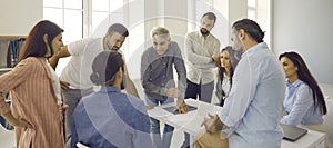 Group of people meeting in office and having discussion with senior business teacher