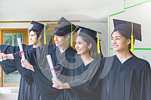 A group of people multietnic students celebrating their graduation. Education, qualification and gown concept