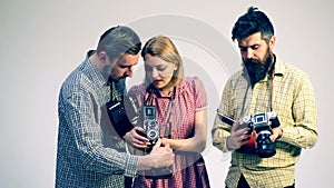 Group of people with old cameras. Concept of the camera. Guys and girl work with cameras.