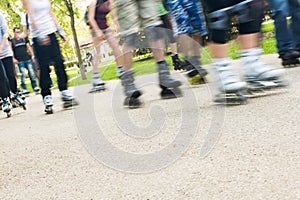 Group of people in park skating,