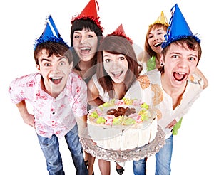 Group of people in party hat with cake.