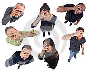 Group of people peeking with hand on face on white background