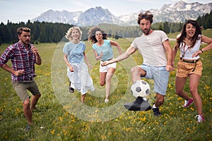 Group of people playing with ball. sport outdoors of a group of friends having fun playing soccer football