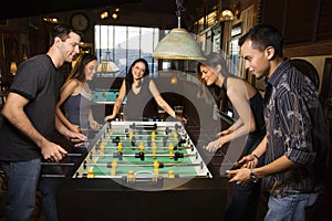 Group of People Playing Foosball