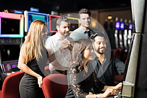 Group of people playing in slot machine