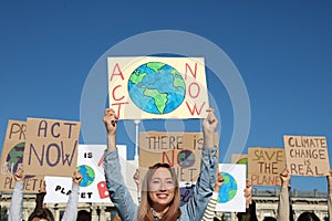 Group of people with posters protesting against climate change outdoors