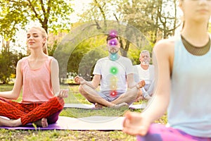 Group of people practicing yoga in park