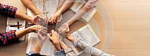 Group of people praying together while holding hand. Top view. Burgeoning.