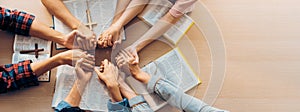 Group of people praying together while holding hand. Top view. Burgeoning.