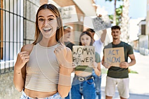 Group of people protesting and giving slogans at the street screaming proud, celebrating victory and success very excited with