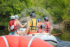 Group of people in a rafting boat, beautiful adrenaline ride down the Pacuare River,