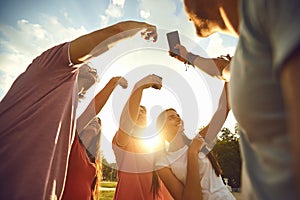 A group of people raised their hands up with mobile phones